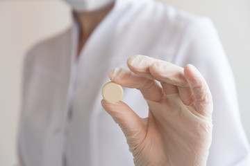 A gloved doctor holds a tablet in his hand. The sign is approx. The concept of care and safety.