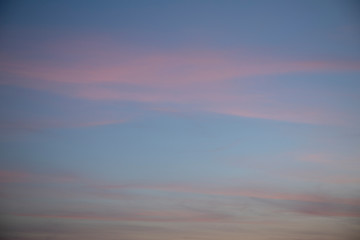 Moody blue sky with pink clouds.
