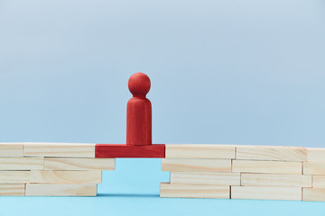 Business risk. Danger and chance. Mockup style for design. Copy space. Red wooden figures stands on plank of bridge gap