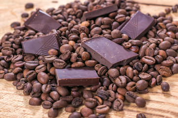 Broken slices of chocolate and coffee beans