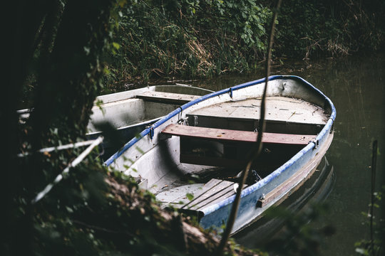 Small fishing boat on the lakeshore.