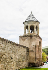 Fototapeta na wymiar Bell tower at the entrance to the courtyard of Svetitskhoveli Church. Georgia