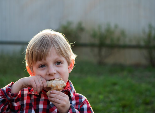 Caucasian Boy Eats A Chicken Drumstick Cooked On The BBQ Delicious