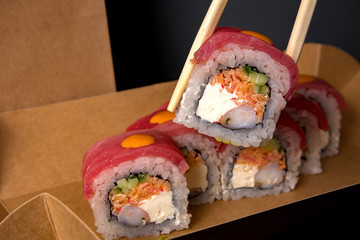 sushi and sushi sticks on a dark background