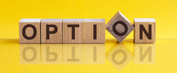 OPTION - word from wooden blocks with letters, sorry concept, yellow background.
