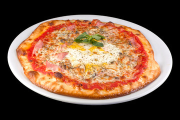 Capricciosa pizza with tomato sauce, bacon, ham, pepper, corn, yellow cheese on a plate, isolated on black background
