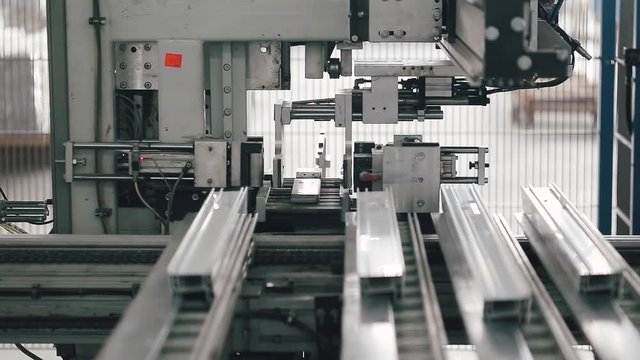 Automatic machine in Factory for UPVC windows and doors production. Manufacturing jobs. Factory Work on the production of PVC windows. UPVC window production technology.