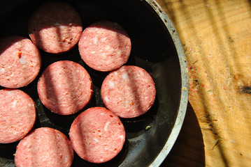 
sausage in a pan on a wooden board. home kitchen