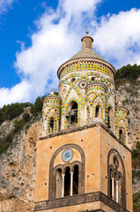 Close up of bell tower, Amalfi Cathedral, Cattedrale di Sant'Andrea Duomo di Amalfi . Roof is covered with typical green majolica tiles common in Southern Italy.