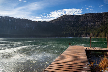 Beautiful volcanic frozen lake in Carpathian Mountains in Romania