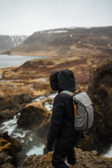 Male with backpack and winter outfit in icelandinc landscape