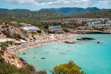 Fototapeta na wymiar Mediterranean Sea beach at Ibiza island, stunning seaside scenery of Cala Tarida, Spain Balearic Islands.