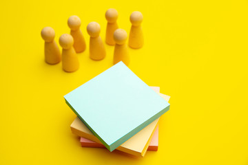 Teamwork, teambuilding mockup, company structure. Wooden figures stands near sticky notes, place...