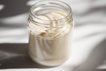 Yeast during fermentation closeup in a glass jar