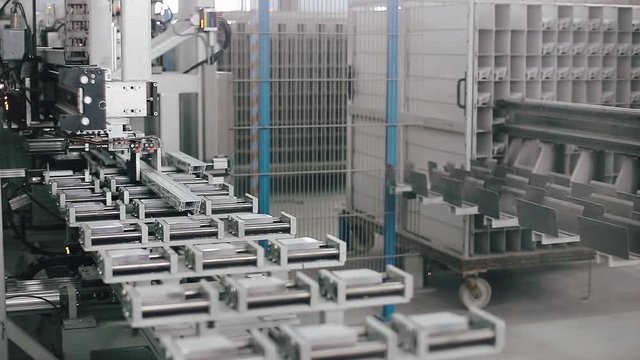 Automatic machine in Factory for UPVC windows and doors production. Manufacturing jobs. Factory Work on the production of PVC windows. UPVC window production technology.