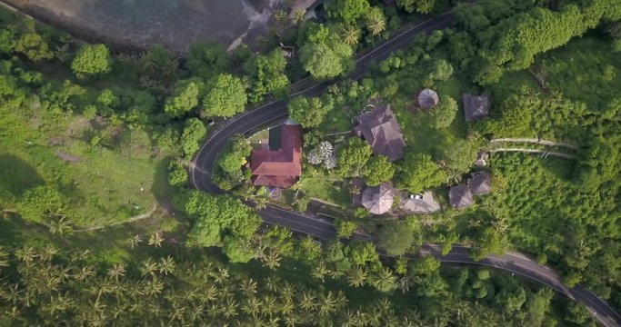 Aerial shot of tropical road and village in the jungle island