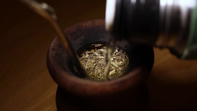Hot water pouring over a Argentine Mate cup