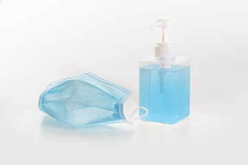 Hygienic mask and a bottle of alcohol based hand sanitizer gel on white background protect from virus covid 19 n95 pollution