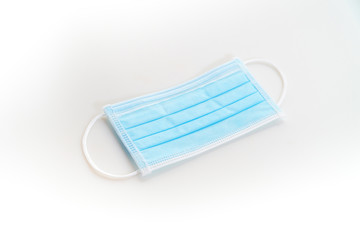 Disposeable blue Hygienic mask on white background protect from virus covid 19 n95 pollution