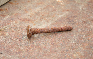 
old rusty bolt on a rusty background