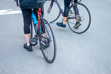 athletic couple outdoors on bikes at a street stop