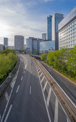 Paris, France - 04 16 2020: Panoramic view of the Defense circular boulevard district at sunset.