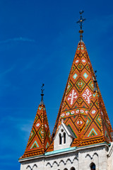 Fototapeta na wymiar Tiled roof of Matthias Church on the hill in Budapest, Hungary.