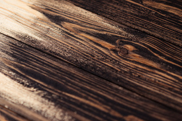 Fototapeta premium Painting a wooden surface with paint, stain. On a label or banner and advertising surface. Wooden boards are half covered with stain. The painting process, the layout.
