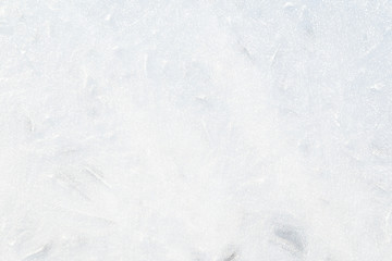 Close-up of bright ice on a frozen lake in the winter. Abstract full frame background. Copy space.