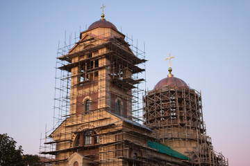 Construction of a church, wooden scaffolding against a blue sky