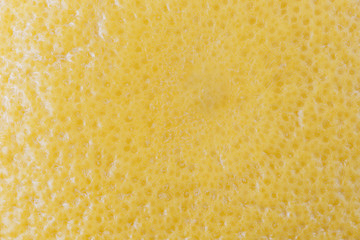 Macro close-up of a ripe yellow grapefruit. Abstact full frame textured background.