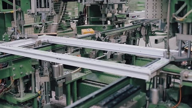 Cleaning of welds on plastic window. Factory for PVC windows and doors production. Machine for trimming welded seams. Welding of PVC window profile. Production of plastic windows.
