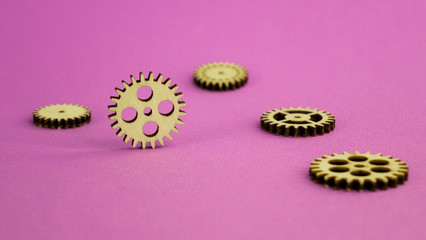 Wooden details mechanism. lying on a pink background