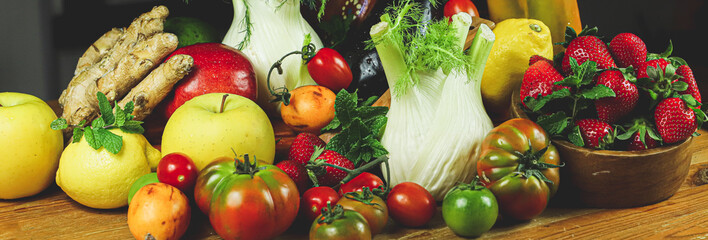 full frame of a rustic composition of fruit and vegetables arranged on a table