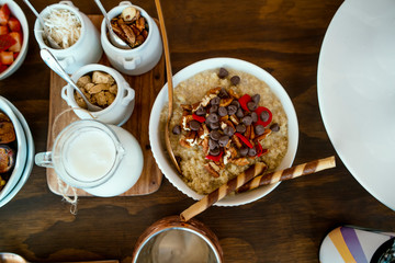 Fototapeta na wymiar Healthy breakfast with cereal, coconut, chocolate chips, milk, a