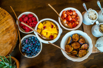 Fruit bowls on wooden table taken from above