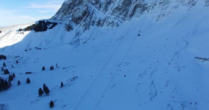 Mountain railway aerial view winter gondola hovering to bottom