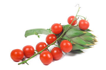 close up of cherry tomatoes and artichokes with white background