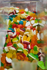 A variety of sweet candies in a store on the counter.