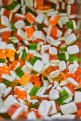 A variety of sweet candies in a store on the counter.