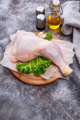 Raw chicken leg on cutting board