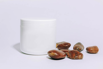 white jar of cream on a white background