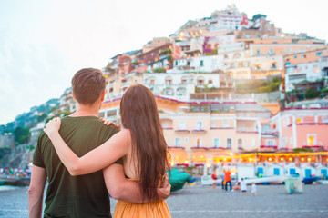 Fototapeta na wymiar Summer holiday in Italy. Young couple in Positano village on the background, Amalfi Coast, Italy