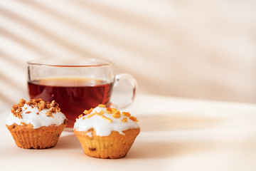 Dessert tea with Muffins on light table. Close up, Copy space.
