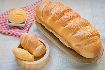 Baked breads on wooden table background.