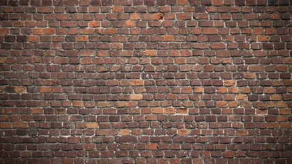 Full frame image of the ancient red brick wall. High resolution texture with dark vignetted corners for background, poster, collage in loft, grunge, vintage or industrial style