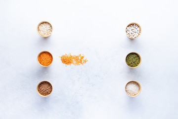 Dry bio cereals in craft bio cups made of paper on a gray background. Concept of healthy food with home delivery. Top view, Copy space.