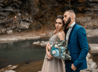 Happy marriage couple in love. Loving man and woman at marriage day. Newlyweds holding hands. bearded groom and bride