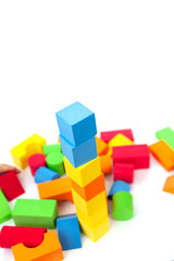 Obraz premium Bright multi-colored details of the designer. Children's toy on a white background. Background of colorful toy figures.