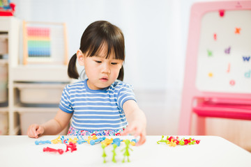 Fototapeta premium toddler girl learning counting and math for homeschooling